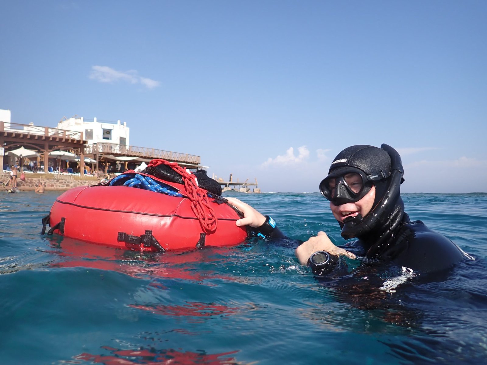Freediver descending into deep blue water